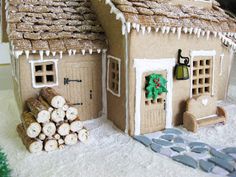 a gingerbread house is decorated with icing and decorations