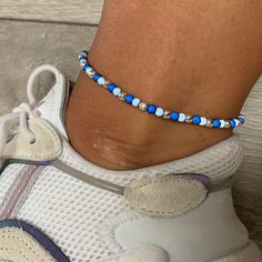 🌸 navy blue, sky blue and silver miracle bead anklet 🌸  ♥️Catches the light to give off a glow!  ♥️Perfect for nights out or even holidays!  ♥️Please message me if you have any questions each  ♥️ All anklets are made on rope. The two ends will need to be tied together and in a double knot so that the anklet does not come off. These are safe to wear in water.  Also available with matching bracelets, earrings and chokers! The colour may vary slightly due to most images being taken under direct sunlight or with flash to show you the full effect of the beads x  White beads may appear grey/silver when opened in a dark room. The full effect of the beads will shine through in different lights. Please note: Buyer pays for any return postage/ exchange postage x Blue Beaded Bracelets For Summer Festival, Blue Beaded Bracelets With Silver Beads For Beach, Adjustable Blue Anklets For Festival, Blue Tiny Beads Anklet For Gift, Blue Anklet With Tiny Beads For Gift, Blue Beaded Bracelets With Silver Beads For Festivals, Adjustable Blue Anklets As Gift, Casual Blue Anklets With Round Beads, Casual Blue Beaded Anklets