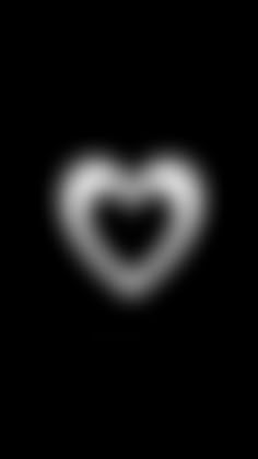 a black and white image of a heart in the dark