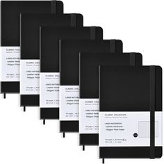 five black and white notebooks lined up against each other