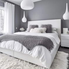 a white bed sitting in a bedroom on top of a fluffy rug next to a window