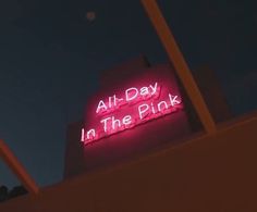 a neon sign on the side of a building that says all day in the pink