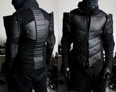 two mannequins dressed in black leather and one wearing a full body armor