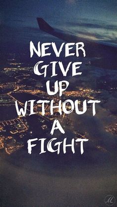 an airplane wing with the words never give up without a flight above it at night