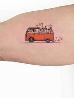 an orange van with two dogs on the roof is shown in this small tattoo design