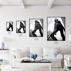 three black and white photographs hang on the wall above a couch in a living room