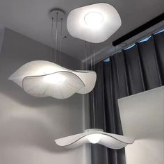 three lights hanging from the ceiling in a room