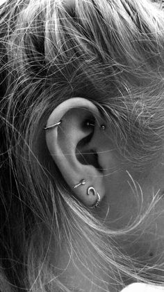 a woman's ear is shown in black and white