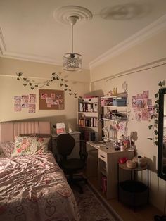 a bedroom with a bed, desk and shelves on the wall next to each other