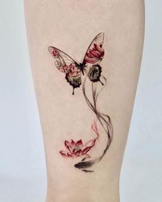 a woman's leg with a butterfly and flower tattoo on the lower side of her body