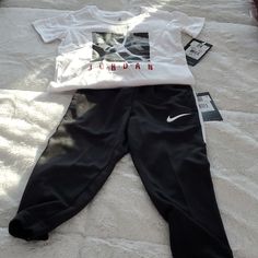 Nike Air Jordan T-Shirt And Black Nike Elastic Pullover Jogging Pants With Outside Ankle Zippers. The Jogging Pants Do Have Two Side Pockets. The Pants Are 2t And The Shirt Is 3t. Nike Casual Loungewear Sets, Nike White Casual Sets, Nike Casual White Sets, White Nike Casual Sets, Casual White Nike Sets, Casual White Pants For Playwear, Nike Casual Streetwear Sets, Nike Tech Sweatsuit, Nike Sweatsuit