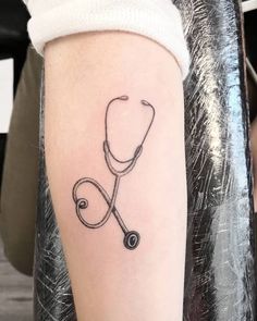 a stethoscope tattoo on the right arm