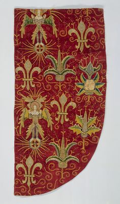 an old red and gold cloth with designs on the edges, including birds and flowers