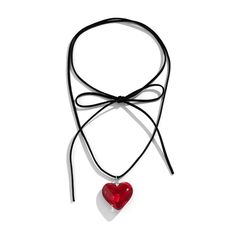 a necklace with a red heart hanging from it's side on a black cord