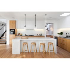 three stools are in front of the kitchen island