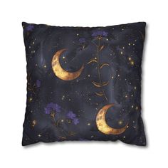 a decorative pillow with the moon and flowers on it, against a dark blue background