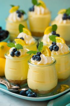 two pictures of desserts with lemon and blueberries in them, one is topped with whipped cream