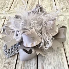 Leave a lasting impression with this showy and spectacular silver girl's hair bow. Traditional gray colored ribbons loop together artfully, creating an exquisite and eye catching over the top hair bow for babies and toddlers. Big, beautiful and oh so stunning. Finished with gray ostrich feathers and shimmering rhinestones. This beautiful Solid Gray Ruffled Over the Top Hair Bow or Baby Headband comes attached to your choice of alligator clip, French barrette, or as a bow and headband set. - made Baby Hair Bows Headbands, Handmade Baby Headbands, Stacked Hair Bow, Birthday Headband, Christmas Hair Bows, Silver Headband, Headband Set, Flowers Ideas, Bow Headband Hairstyles