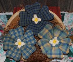 four blue and yellow plaid fabric flowers in a basket