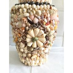 there is a vase made out of seashells