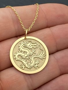 "14k Solid Gold Chinese Dragon Necklace, Personalized Chinese Dragon Pendant, Dragon Symbol Pendant, Chinese Mythology 14k Solid Gold Choose What Size You Want the Pendant Using The First Option Box Choose Chain Length Or Without Chain Using The Second Option Box Photos Are For The 25.4 mm / 1 Inch Diameter Pendant Pendant thickness : 0.7mm  Contact us if you want it thicker Inner diameter of jump ring : 5mm Contact us if you need it bigger  Chain width : 1.30mm     ♥ Material of pendant and chain: Solid Gold k14 ♥ Packaging: All of our jewelry are beautifully boxed and ready for gifting For more personalized designs take a look here: ♥ www.etsy.com/listing/736955132 ♥ www.etsy.com/listing/819494857 ♥ www.etsy.com/listing/823397880 ♥ www.etsy.com/listing/769847320 ♥ www.etsy.com/listing/87 Chinese Necklace Pendants, Luxury Elegant Necklace With Dragon Design, Luxury Gold Necklaces With Dragon Design, Luxury Yellow Gold Necklace With Dragon Design, Flower Necklace Outfit, Necklace Gold Indian, Choker Necklace Outfit, Gold Chinese Dragon, Small Diamond Necklace