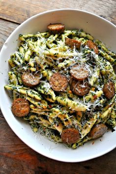 a white bowl filled with pasta and sausage