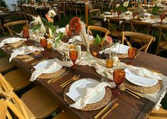 an outdoor table set with plates and place settings