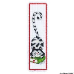 a cross stitch bookmark with a black and white cat holding a green object in it's mouth