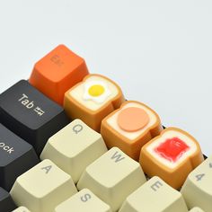 an egg, bacon and cheese on top of a computer key board with the word love spelled below it