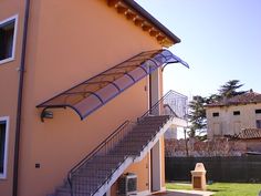 an outside view of a house with stairs leading up to it