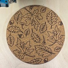 a cork board with leaves and berries on it next to a pair of blue scissors