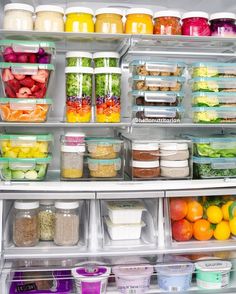 an open refrigerator filled with lots of food and containers full of fruit, vegetables, and other foods