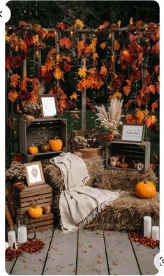 an outdoor area with hay bales and pumpkins