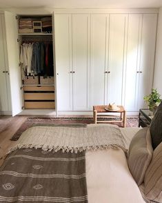 an image of a bedroom setting with closets in the background and bed on the floor