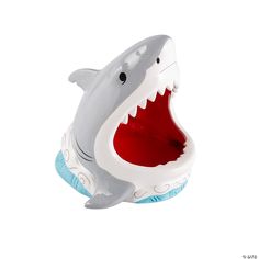 a toy shark with its mouth open on a white background