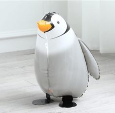 an inflatable penguin is sitting on the floor