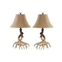 two lamps with antlers on them sitting next to each other in front of a white background