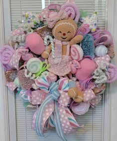 a wreath that has a teddy bear on it