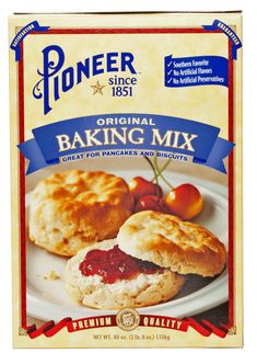 a box of baking mix on a white plate with cherry tomatoes and biscuits