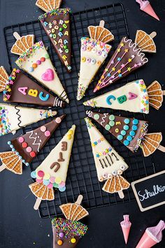 there are many decorated cookies on the cooling rack