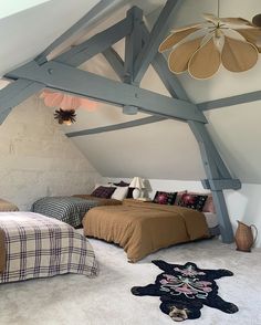 an attic bedroom with two beds in it