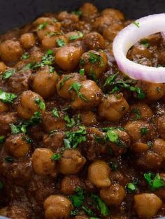 a bowl filled with meat and onions on top of a table