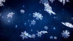 snowflakes are flying in the air on a dark blue background