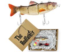 a fish is hanging from a hook next to a box with fishing lures