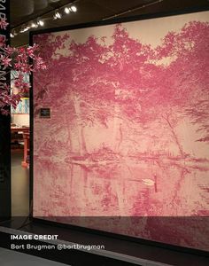 a large pink painting on display in a room