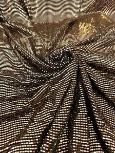 "I love ordering from this company. Everything I have ordered has always been what I wanted." Sarah B. Verified Kikitextiles Customer ✅ Bring on the shimmer with our very sparkly Metallic Gold Flat Sequins on Black Glittery Knit. At full glimmer, this medium-weight sequined fabric is a 4 way stretch. Fully opac, this fabric doesn't require a lining. This fabric is made up of a combination of materials including knitted spandex and sequins. The fabric has a shiny, reflective surface due to the pr Sequined Fabric, Sequin Knit, Sarah B, Gold Flats, Reflective Surfaces, Small Mirrors, Metallic Gold, Event Decor, Medium Weight