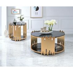 two round tables with black tops and gold trimmings in a living room setting