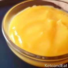 a bowl filled with yellow liquid sitting on top of a table