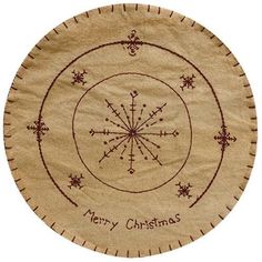 a circular christmas ornament with the words merry christmas on it