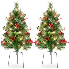 two christmas trees with lights and ornaments on them are shown in front of a white background